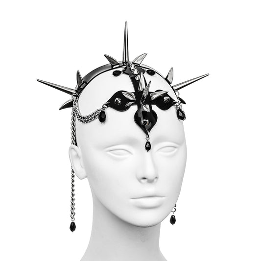 Profile view of gothic headdress with a black PVC headband, three spike clusters, an inverted cross with spikes, and stainless steel chains with black glass beads.