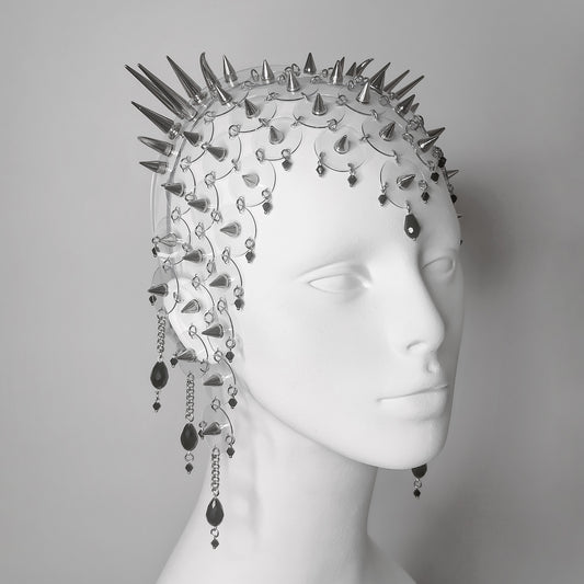 Intricate gothic headpiece featuring clear PVC discs, sharp silver spikes, and delicate hanging chains with black glass teardrop beads.
