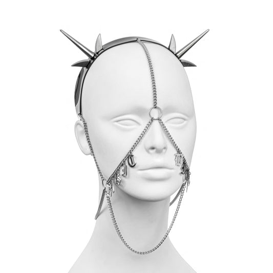Striking alternative headdress with a black PVC headband, silver spikes, and draping chains, fully displaying 'BASIC B1TCH' in bold stainless steel gothic lettering across both cheeks.