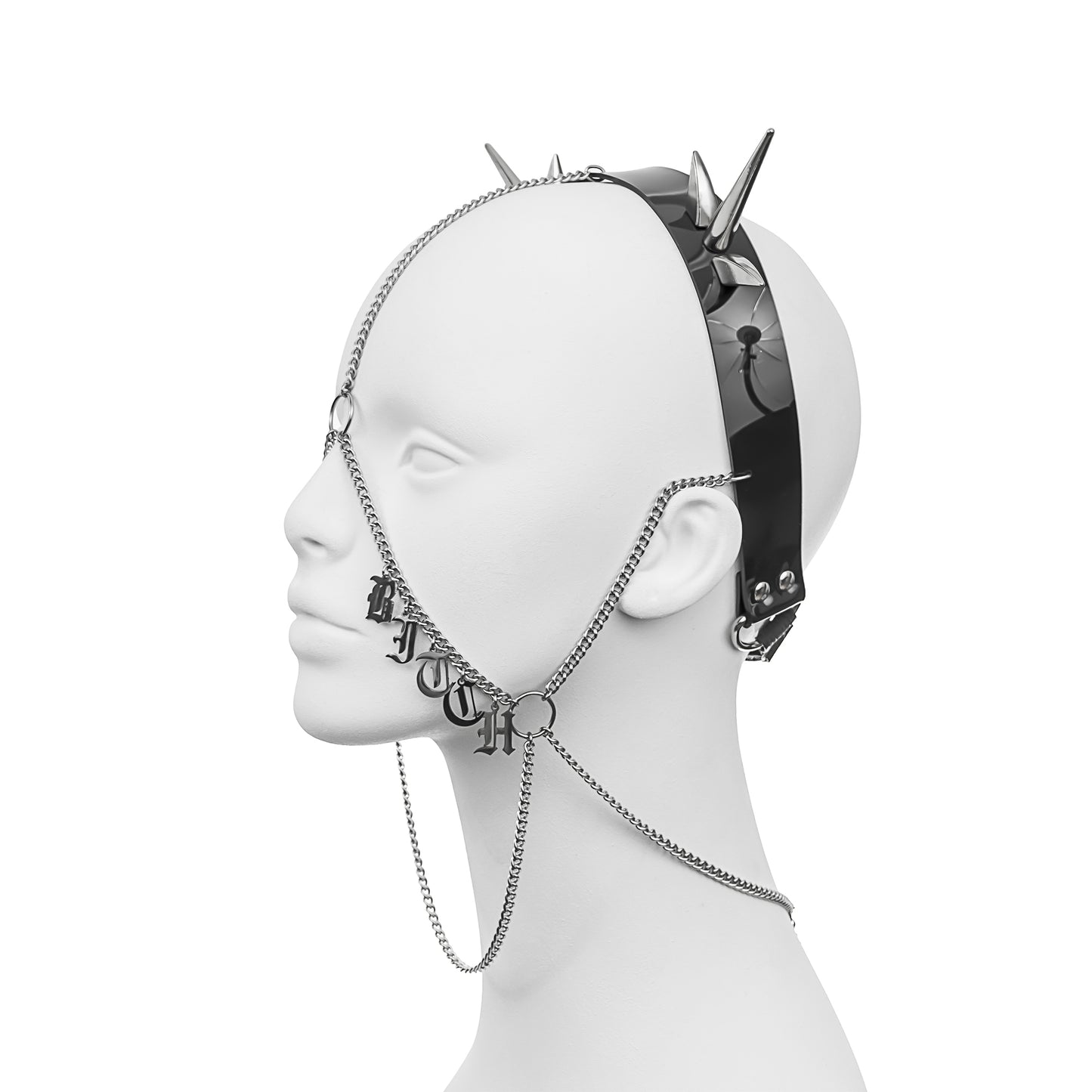 Alternative gothic headdress with a PVC headband, silver spikes, and face chains, displaying the word 'B1TCH' in stainless steel gothic lettering across the left cheek, part of 'BASIC B1TCH'.