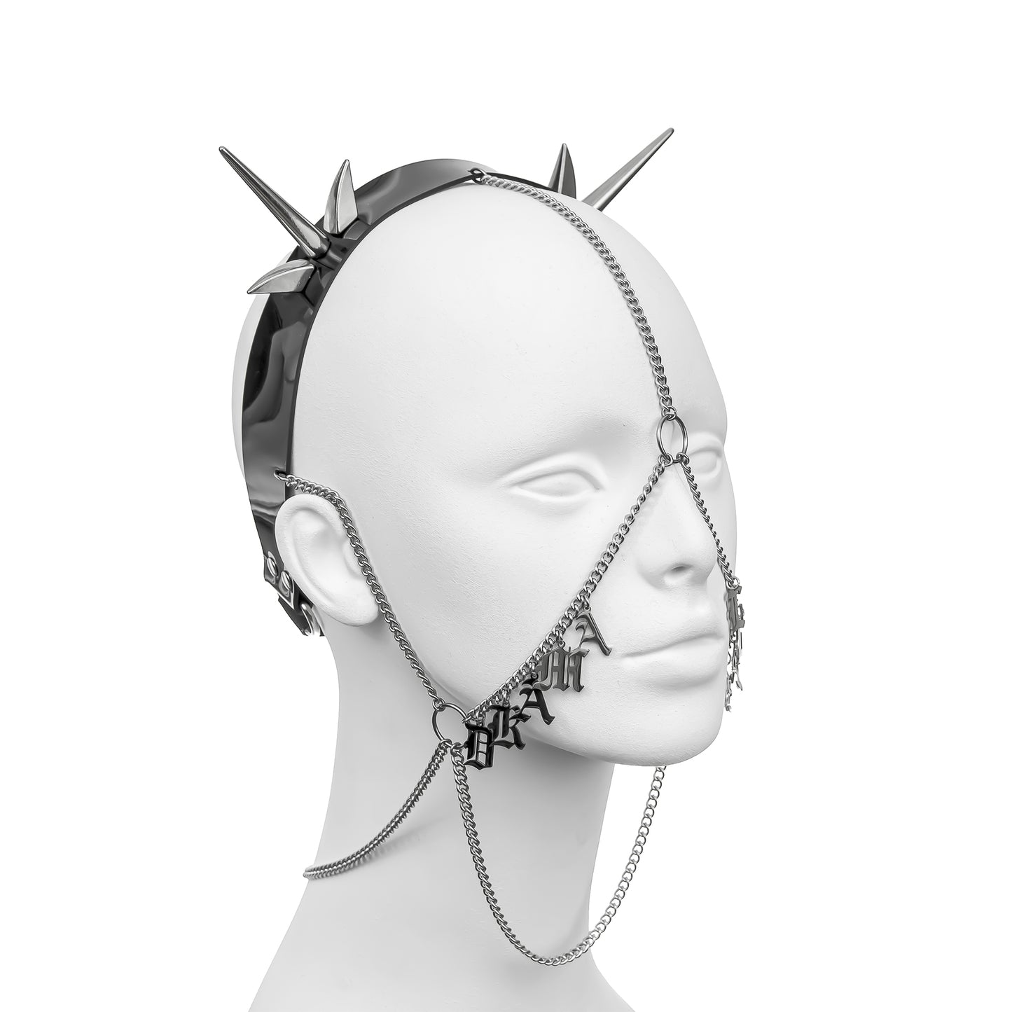 Dark alternative headdress with a black PVC headband, silver spikes, and cascading face chains, displaying 'DRAMA' in stainless steel gothic lettering across the right cheek, part of 'DRAMA LLAMA'.