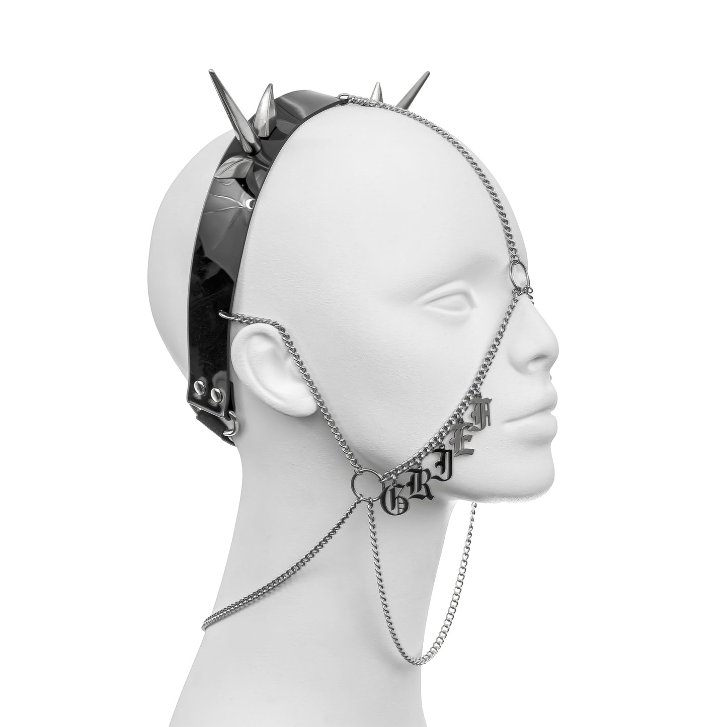 Gothic headdress with a black PVC headband, silver spikes, and draping chains, featuring 'GRIEF' in stainless steel gothic lettering across the right cheek, part of 'GRIEF THIEF'.
