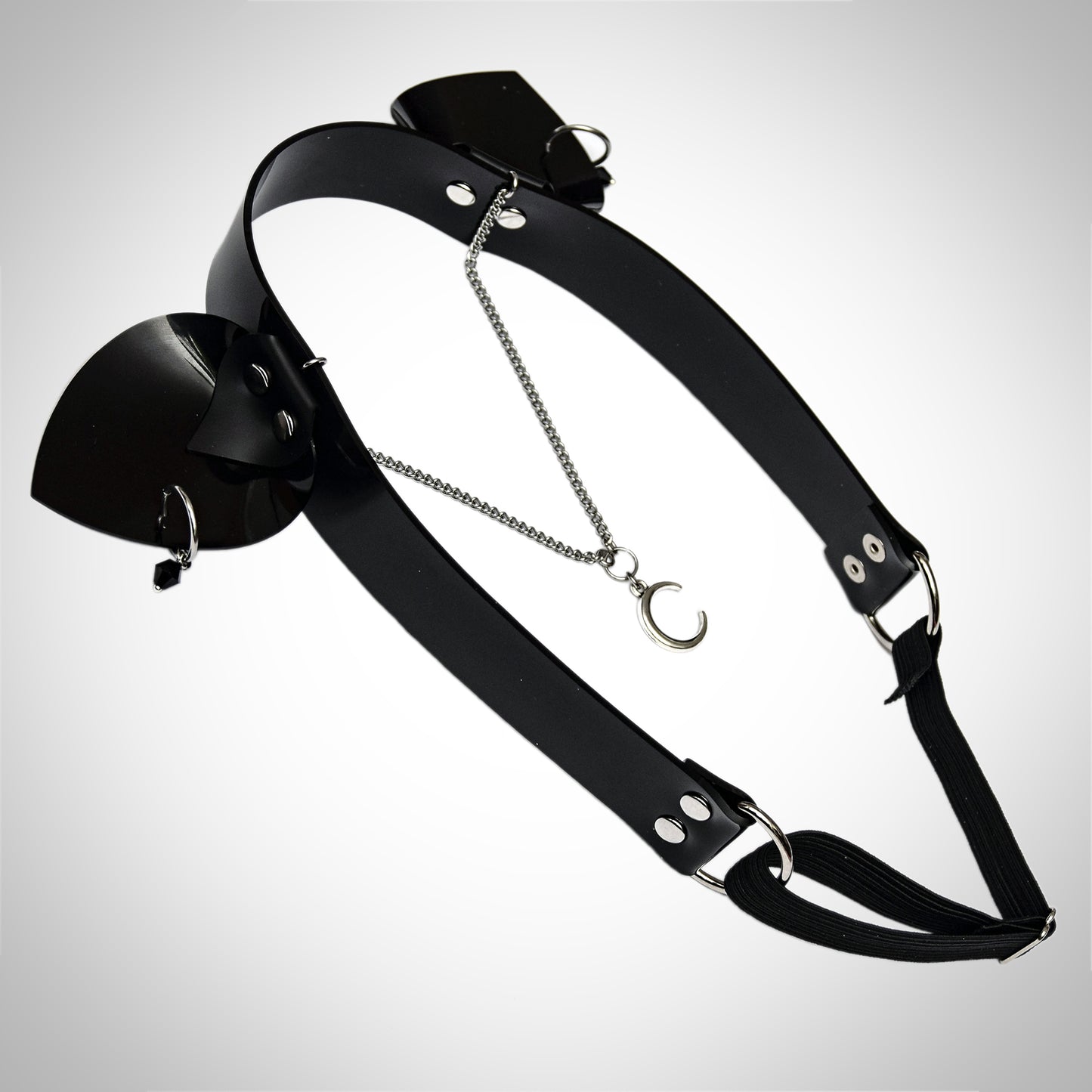 Black PVC headband with pierced cat ears, studded details, and a delicate chain across the forehead featuring a crescent moon pendant.