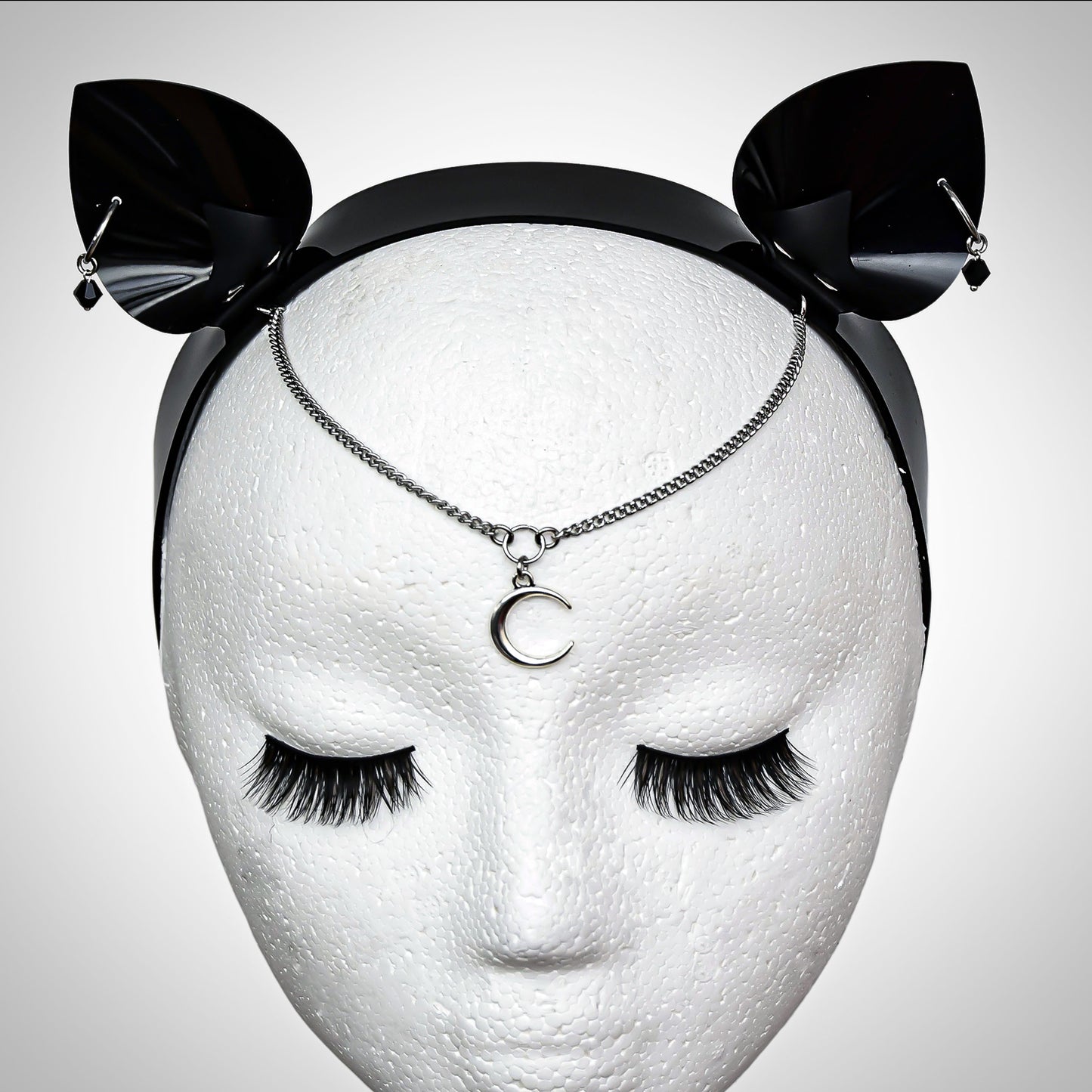 Cat Ear Headband with crescent moon forehead pendant, pierced ears with black gem. Front view