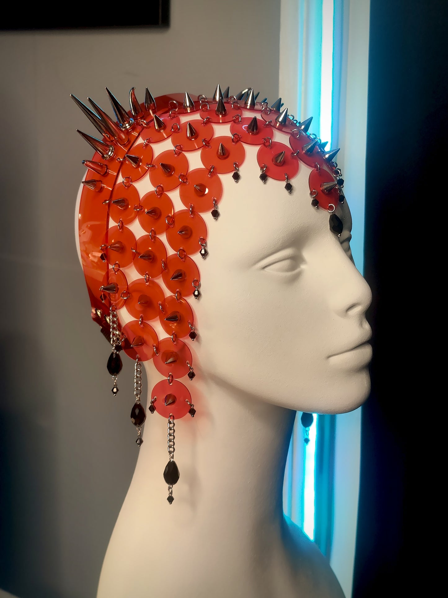 Left profile Intricate gothic translucent red PVC headdress with symmetrical double spike clusters, delicate chains, and black glass teardrop beads.