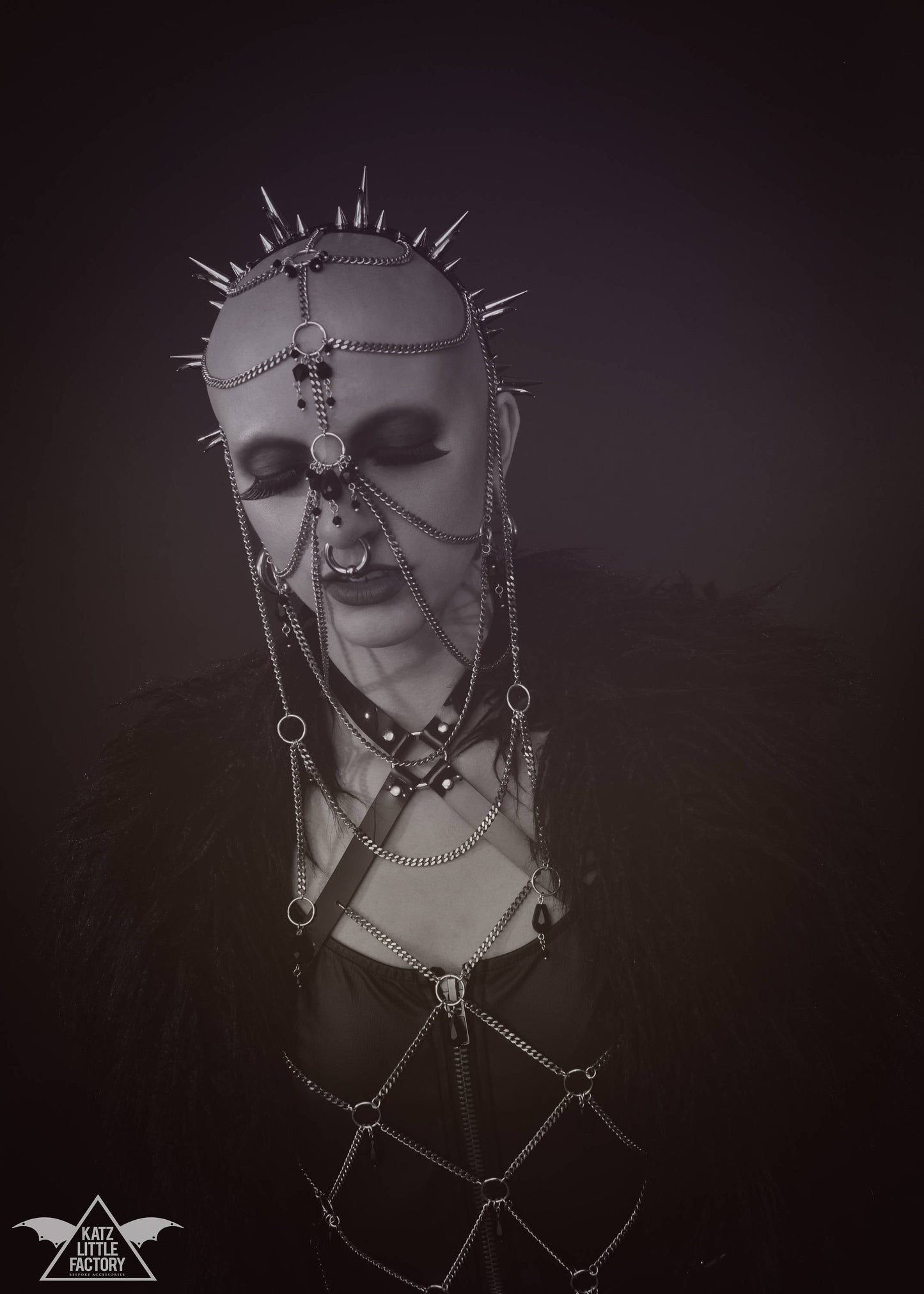 Model wearing elaborate gothic headdress with a black PVC headband, clusters of spikes, and stainless steel chains and black glass beads face jewellery.