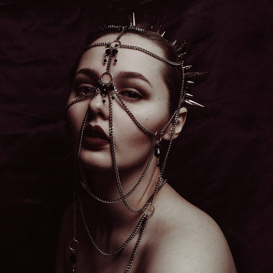 Model wearing elaborate gothic headdress with a black PVC headband, metal spikes, and stainless steel chains and black glass beads face jewellery.