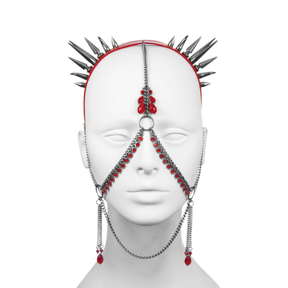 Front view of a gothic headdress with double spike clusters on a red PVC headband, with red glass beads and stainless steel chain face jewellery.