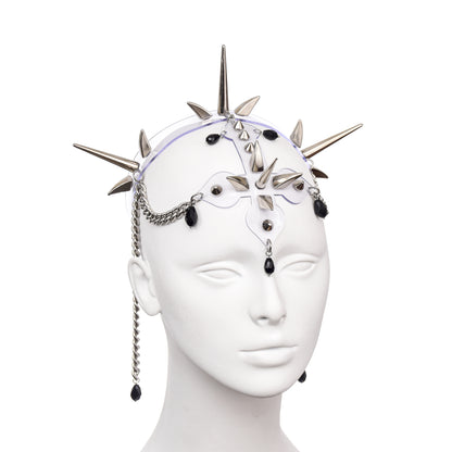 Clear PVC statement headpiece featuring geometric silver spike accents, inverted cross motif, and suspended chains with black glass teardrop beads - ethereal yet bold haute couture accessory for alternative fashion styling