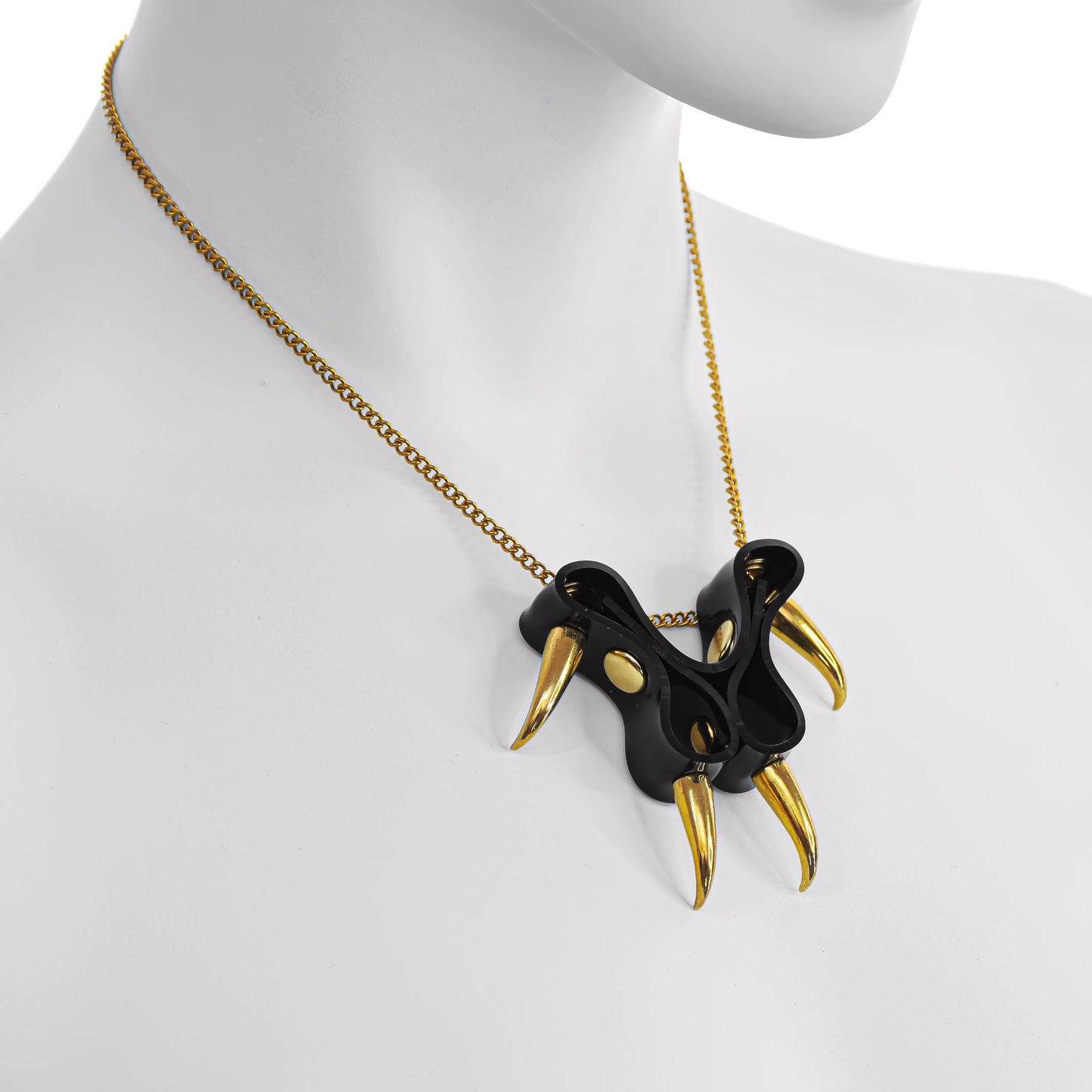 CLAWZ cat paw necklace crafted from gloss black PVC and embellished with gold spikes and chain