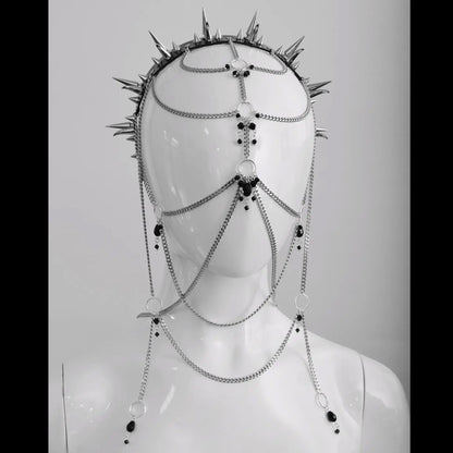 Close-up of a metal chains and black bead headpiece with sharp metal spikes, displayed on a white mannequin. The headpiece is showcased in a studio setting with a plain background, emphasizing its gothic and alternative design.