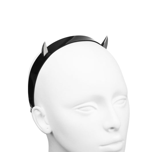 Close-up of gothic gloss black PVC headband with two stainless steel devil horn spikes.