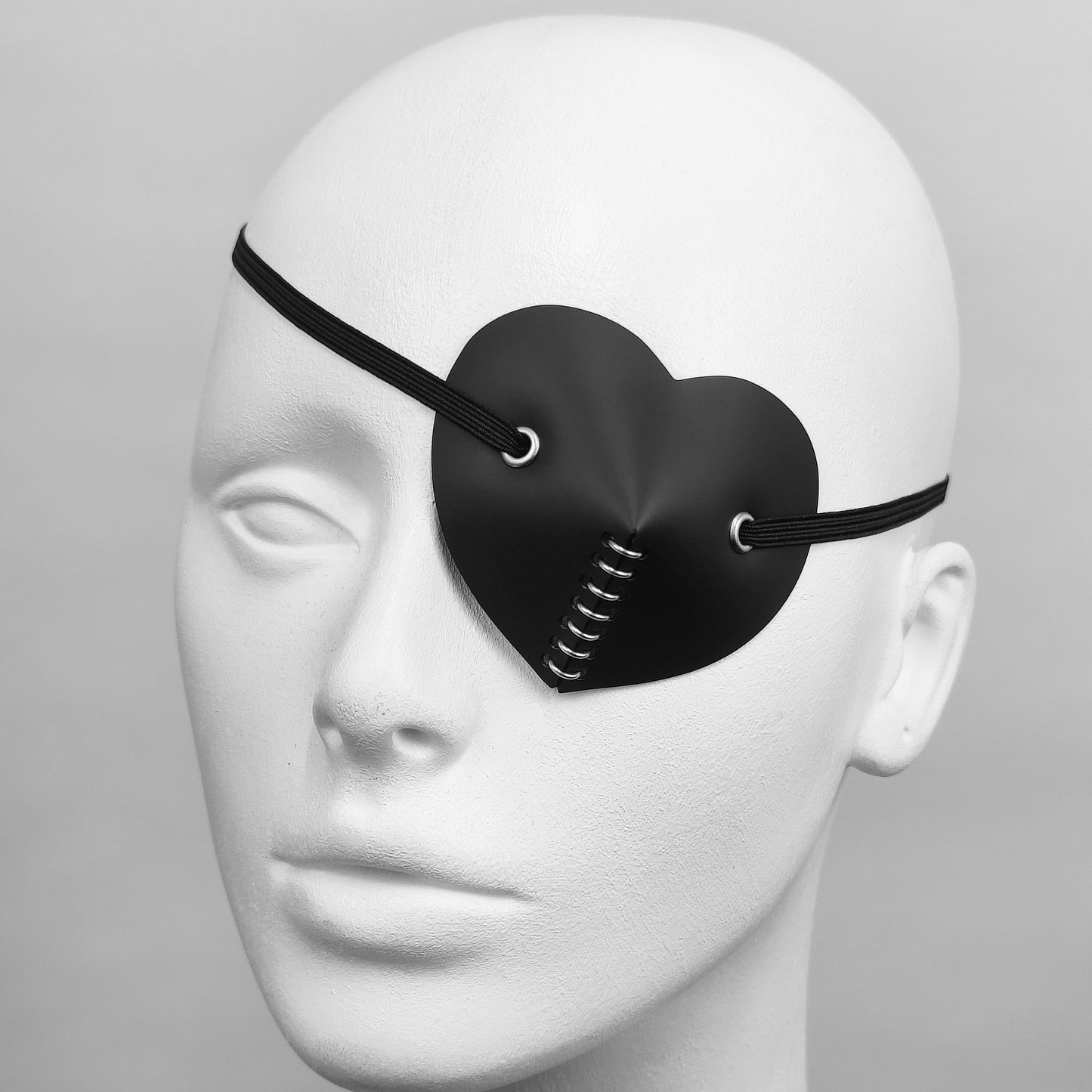 Black heart shape costume eye patch accessory.