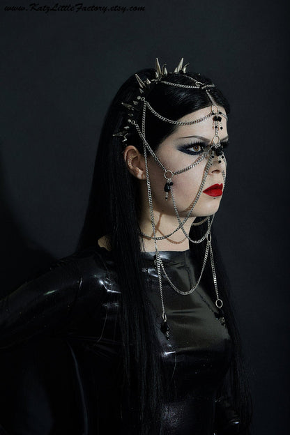 Kat modelling elaborate gothic headdress with a black PVC headband, clusters of spikes, and stainless steel chains and black glass beads face jewellery.
