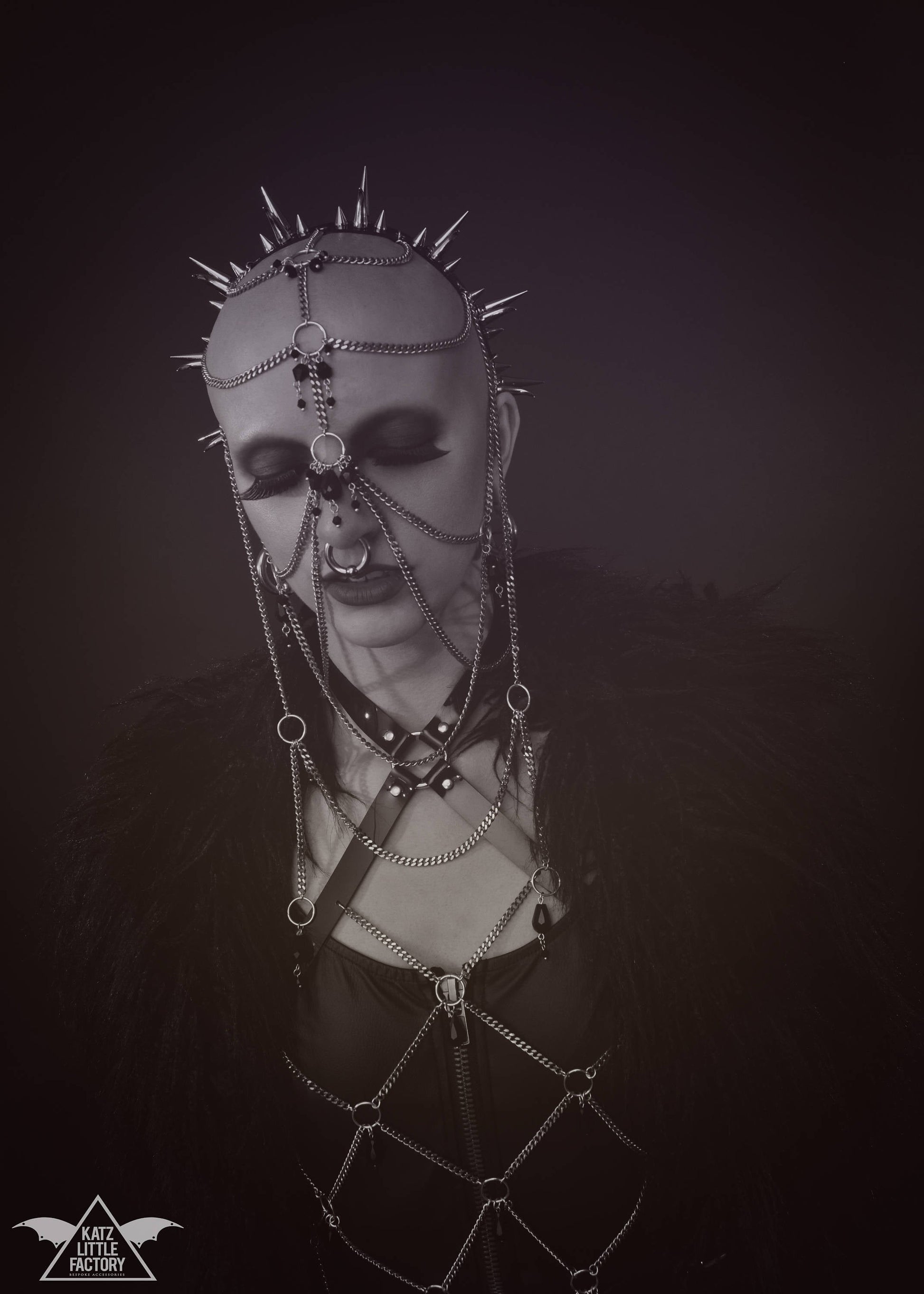 Model wearing elaborate gothic headdress with a black PVC headband, clusters of spikes, and stainless steel chains and black glass beads face jewellery.