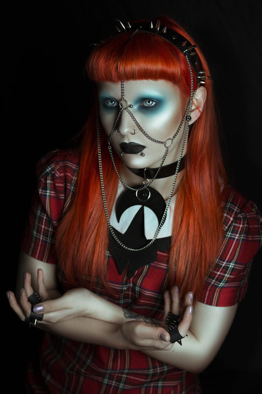 Model wearing a gothic black PVC headdress with spike clusters with  stainless steel chain face jewellery.